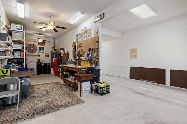 5217 Cedro Elm Dr, Austin, TX 78738 - miscellaneous room with a ceiling fan, concrete flooring, electric water heater, and a workshop area