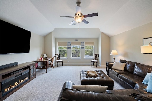 living room featuring a ceiling fan, baseboards, carpet, and vaulted ceiling