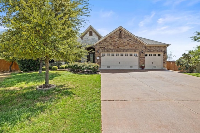 view of front of house with fence, an attached garage, a front lawn, stone siding, and concrete driveway