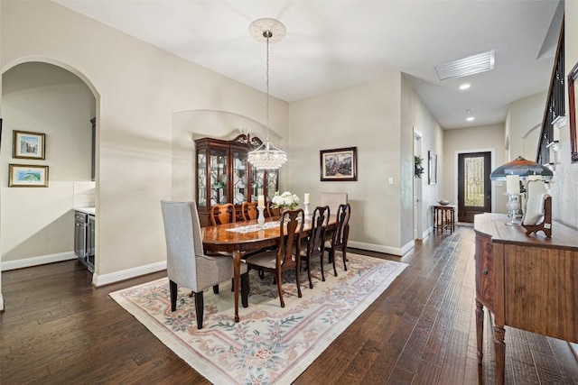 dining area featuring visible vents, baseboards, and dark wood-type flooring