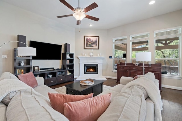 living area featuring baseboards, ceiling fan, recessed lighting, and a wealth of natural light