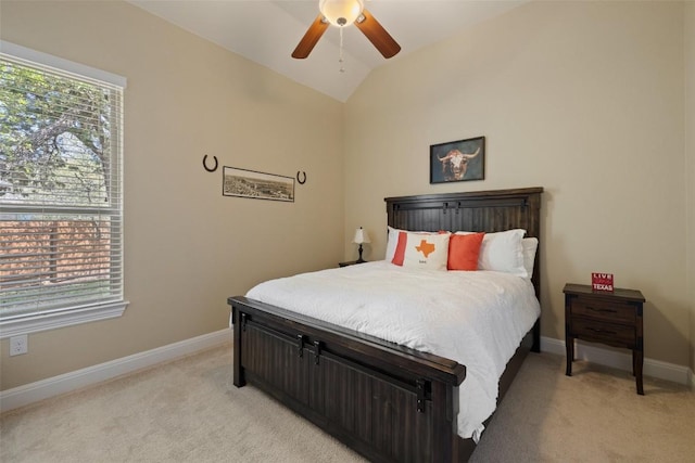 bedroom with baseboards, a ceiling fan, vaulted ceiling, and light colored carpet