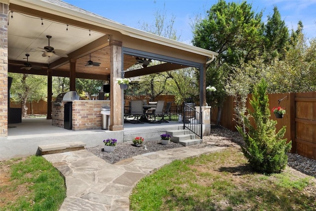 view of home's community featuring an outdoor kitchen, a patio, a fenced backyard, and outdoor dining space