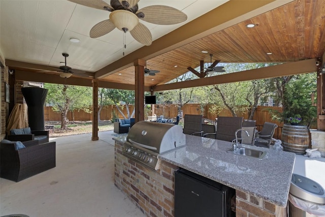 view of patio / terrace with a sink, ceiling fan, and a fenced backyard