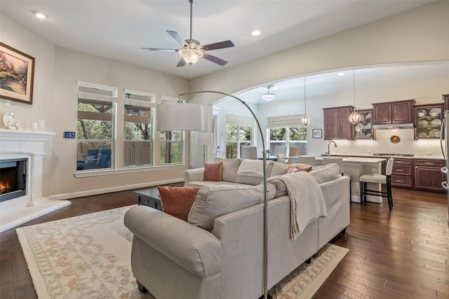 5217 Cedro Elm Dr, Austin, TX 78738 - living area with recessed lighting, ceiling fan, dark wood-type flooring, and a warm lit fireplace