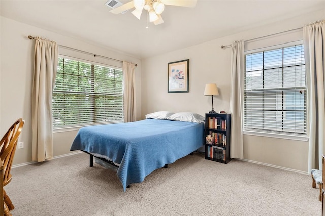 bedroom with baseboards, carpet flooring, a ceiling fan, and visible vents