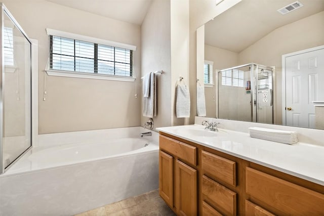 bathroom with vanity, a stall shower, a garden tub, and a wealth of natural light
