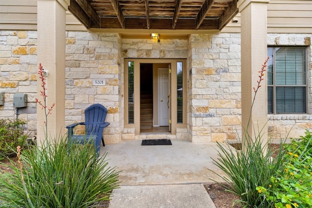 entrance to property with stone siding
