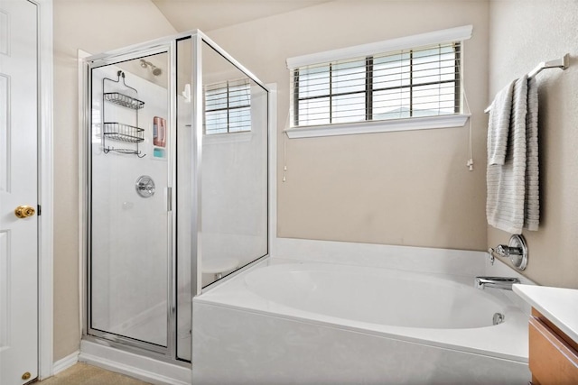 bathroom with a stall shower, a garden tub, and vanity