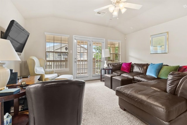 living room featuring ceiling fan, visible vents, light carpet, and lofted ceiling