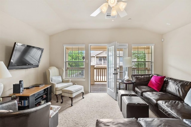 carpeted living area with ceiling fan, visible vents, plenty of natural light, and lofted ceiling