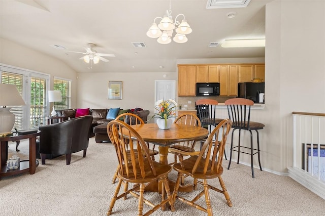 dining area with ceiling fan with notable chandelier, baseboards, light colored carpet, and visible vents