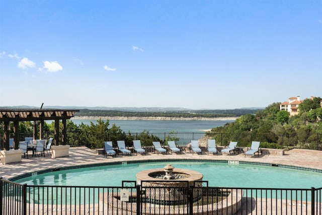 pool featuring a patio, fence, and a water view
