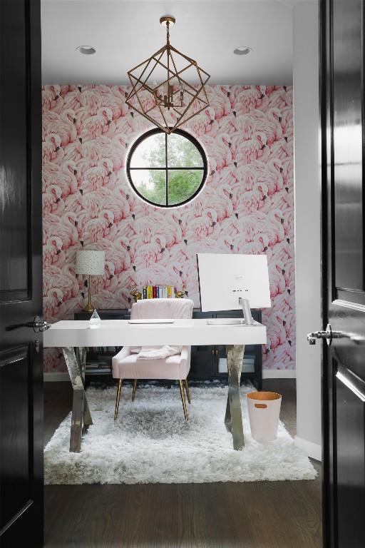 interior space with baseboards, an inviting chandelier, wood finished floors, and wallpapered walls