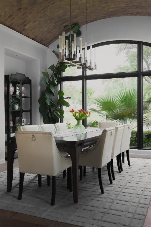 dining space featuring vaulted ceiling and a wealth of natural light