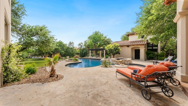 view of pool with a pool with connected hot tub and a patio area