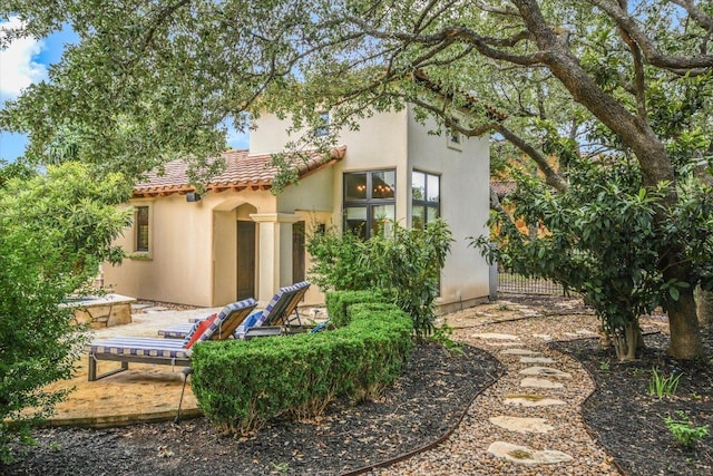 201 Costa Bella Dr, Austin, TX 78734 - rear view of house with a tiled roof and stucco siding