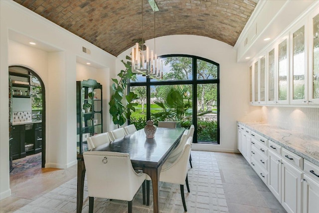 201 Costa Bella Dr, Austin, TX 78734 - dining space with brick ceiling, a chandelier, vaulted ceiling, and recessed lighting