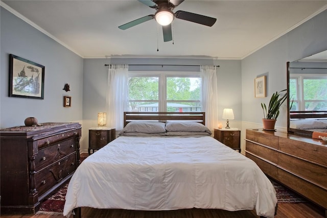 bedroom with ornamental molding, a ceiling fan, and wood finished floors