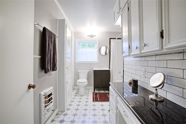 full bathroom with vanity, toilet, tile patterned floors, heating unit, and decorative backsplash