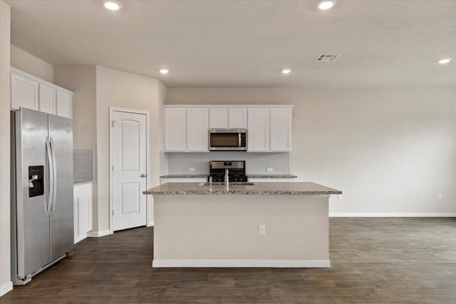 kitchen featuring backsplash, stainless steel appliances, light stone countertops, and visible vents
