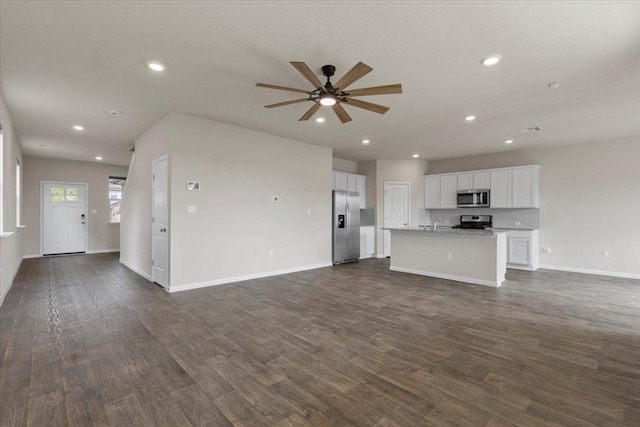 unfurnished living room with recessed lighting, dark wood-style flooring, ceiling fan, and baseboards