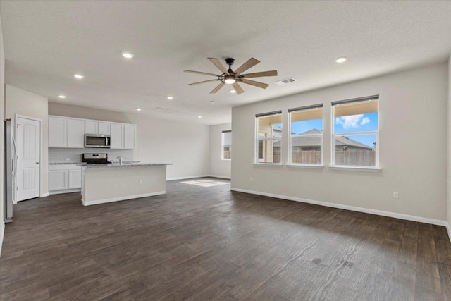 unfurnished living room featuring recessed lighting, a ceiling fan, baseboards, and visible vents