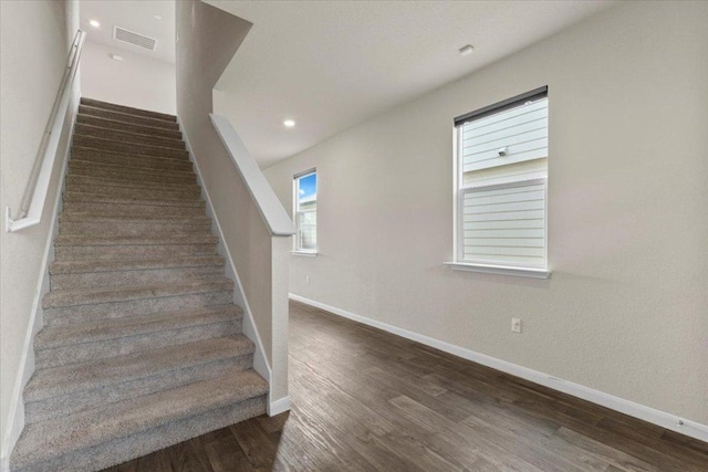stairs featuring recessed lighting, baseboards, visible vents, and wood finished floors