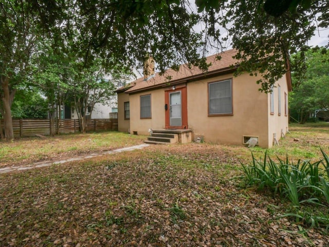 810 E 45th St, Austin, TX 78751 - back of property with a chimney and stucco siding