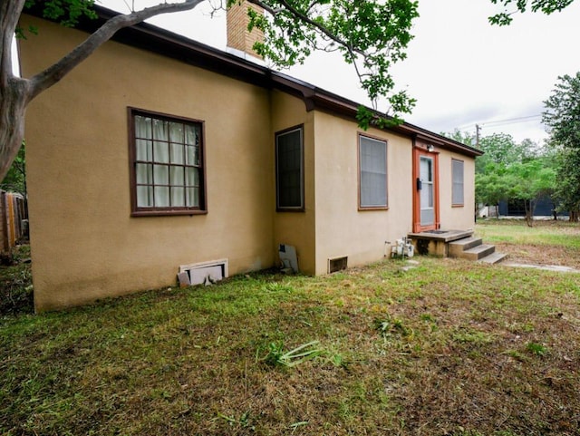 810 E 45th St, Austin, TX 78751 - view of side of home with a lawn, stucco siding, and a chimney