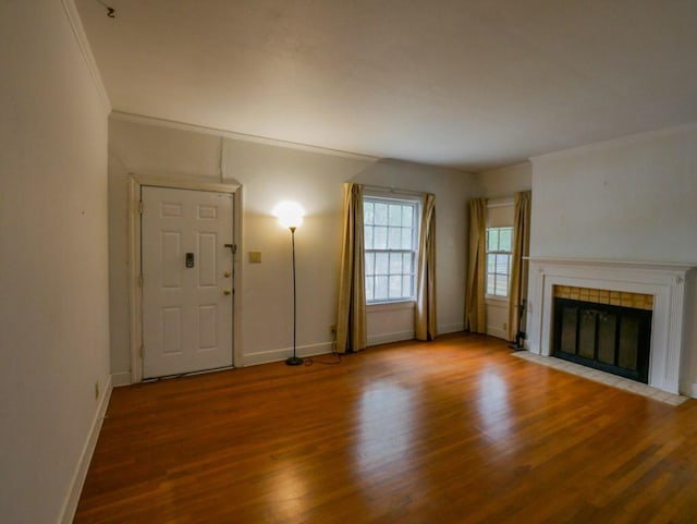 810 E 45th St, Austin, TX 78751 - unfurnished living room with baseboards, ornamental molding, wood finished floors, and a tiled fireplace