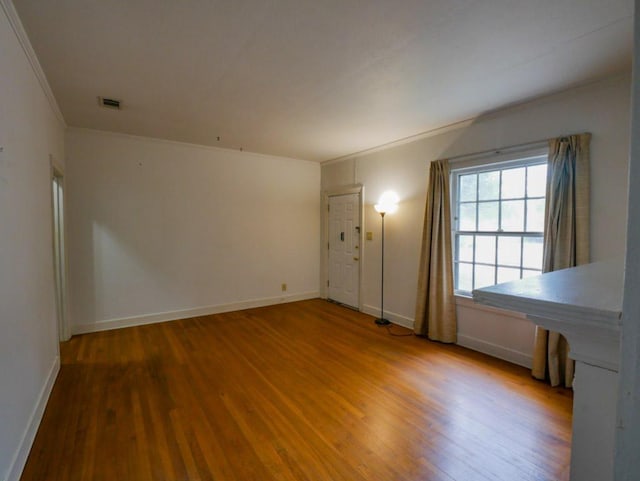 810 E 45th St, Austin, TX 78751 - spare room with crown molding, baseboards, wood finished floors, and visible vents