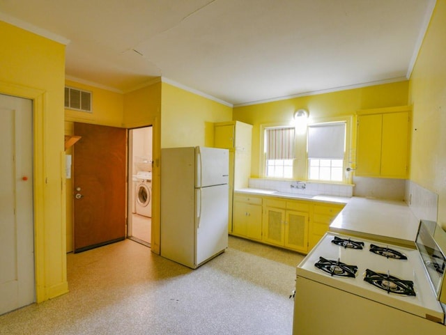 810 E 45th St, Austin, TX 78751 - kitchen featuring a sink, white appliances, light countertops, washer / dryer, and visible vents