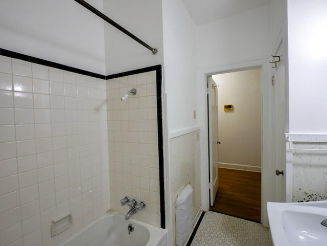 810 E 45th St, Austin, TX 78751 - bathroom featuring tile patterned flooring, wainscoting, and tub / shower combination