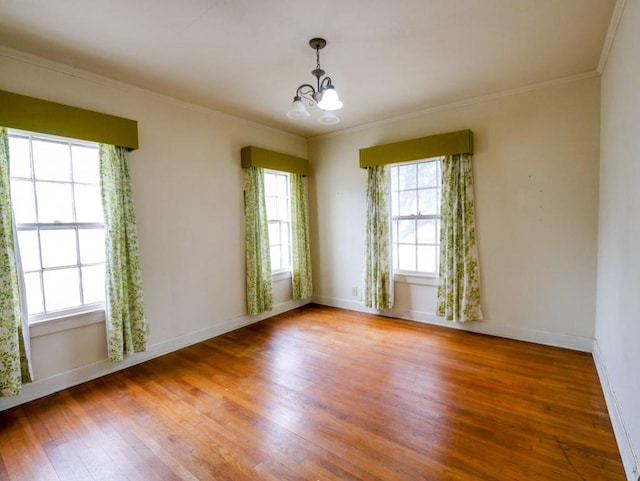 810 E 45th St, Austin, TX 78751 - unfurnished room featuring baseboards, ornamental molding, wood finished floors, and a notable chandelier
