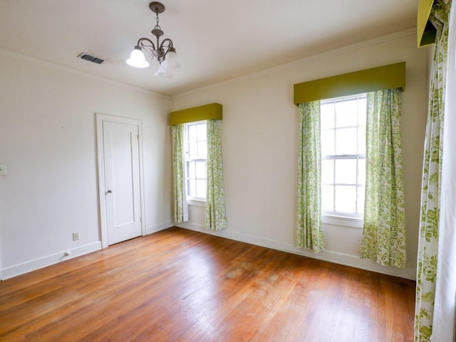 810 E 45th St, Austin, TX 78751 - empty room with baseboards, a notable chandelier, wood finished floors, and visible vents