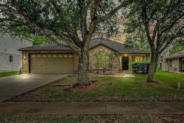 ranch-style house featuring a front lawn, brick siding, a shingled roof, an attached garage, and driveway