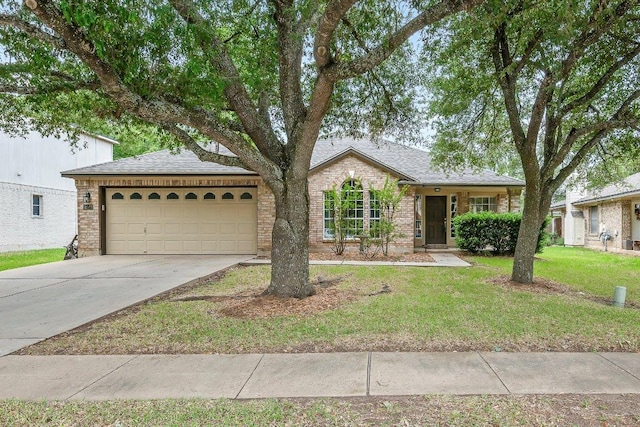 single story home with brick siding, a garage, a front lawn, and concrete driveway