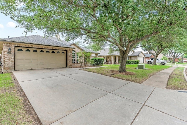 single story home featuring brick siding, an attached garage, driveway, and roof with shingles