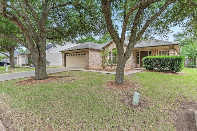 ranch-style house featuring a shingled roof, a front lawn, brick siding, a garage, and driveway