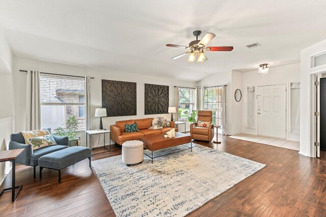 living area featuring a ceiling fan, visible vents, and wood finished floors
