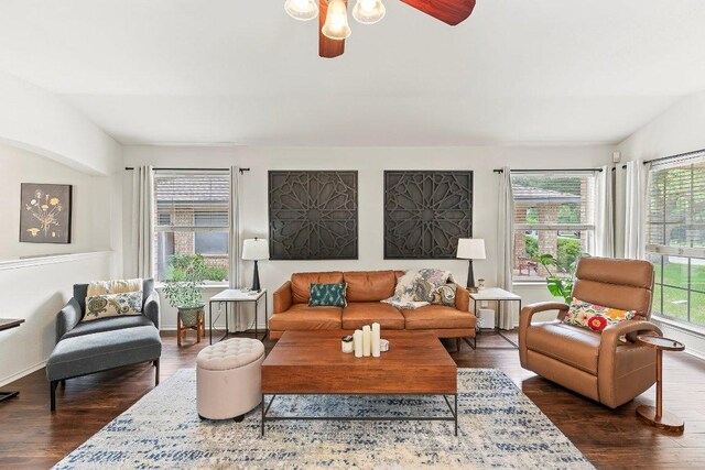 living room featuring a ceiling fan, baseboards, and wood finished floors