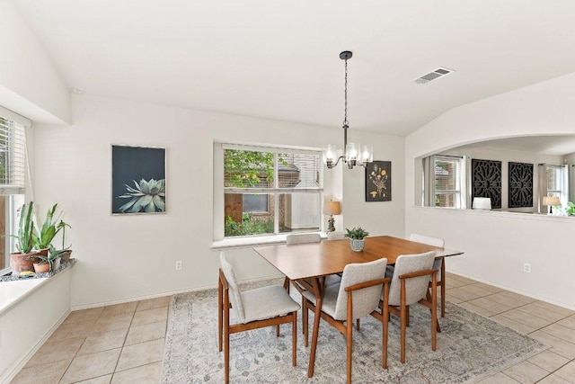 tiled dining room featuring a notable chandelier, visible vents, a healthy amount of sunlight, and lofted ceiling