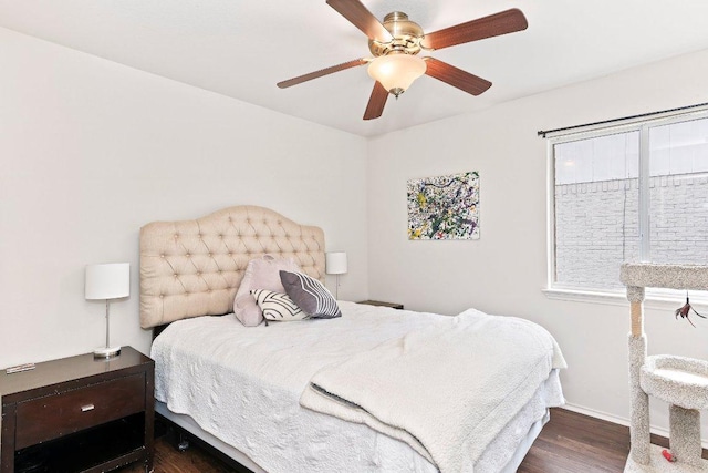 bedroom featuring dark wood-type flooring, baseboards, and ceiling fan