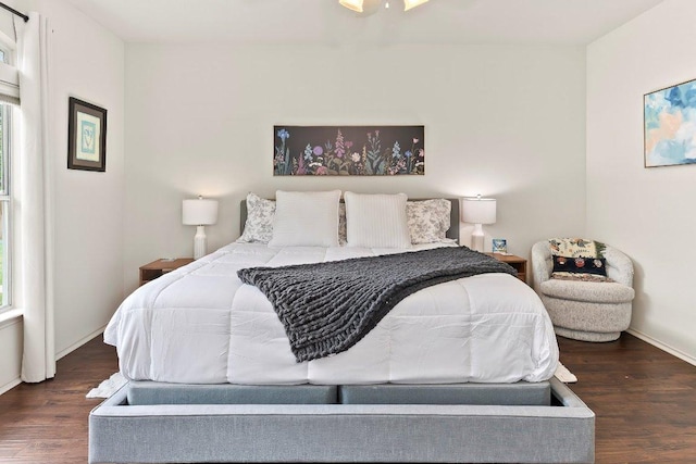 bedroom with baseboards and wood finished floors