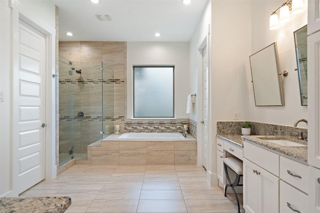831 Sad Willow Pass, Driftwood, TX 78619 - bathroom with vanity, a garden tub, recessed lighting, tile patterned floors, and a shower stall