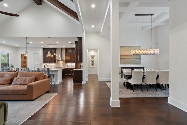 831 Sad Willow Pass, Driftwood, TX 78619 - living room featuring baseboards, a high ceiling, dark wood finished floors, and beam ceiling