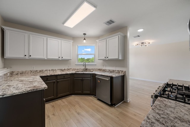 kitchen featuring white cabinets, appliances with stainless steel finishes, a sink, and visible vents
