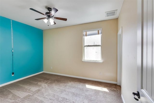 empty room featuring baseboards, carpet flooring, and visible vents