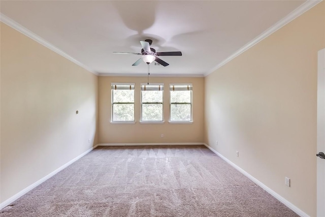 empty room with crown molding, baseboards, light carpet, and a ceiling fan
